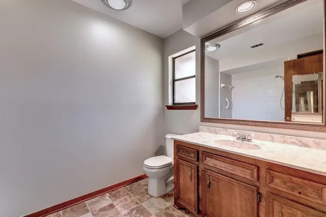 a bathroom with a sink a toilet and mirror