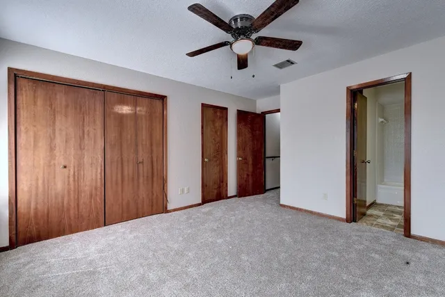 a view of a livingroom with a chandelier fan
