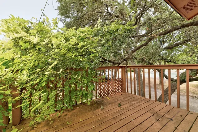 a view of a balcony with wooden floor
