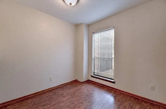 a view of wooden floor and window in a room