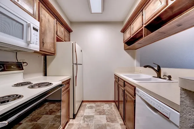 a kitchen with stainless steel appliances granite countertop a stove and a refrigerator