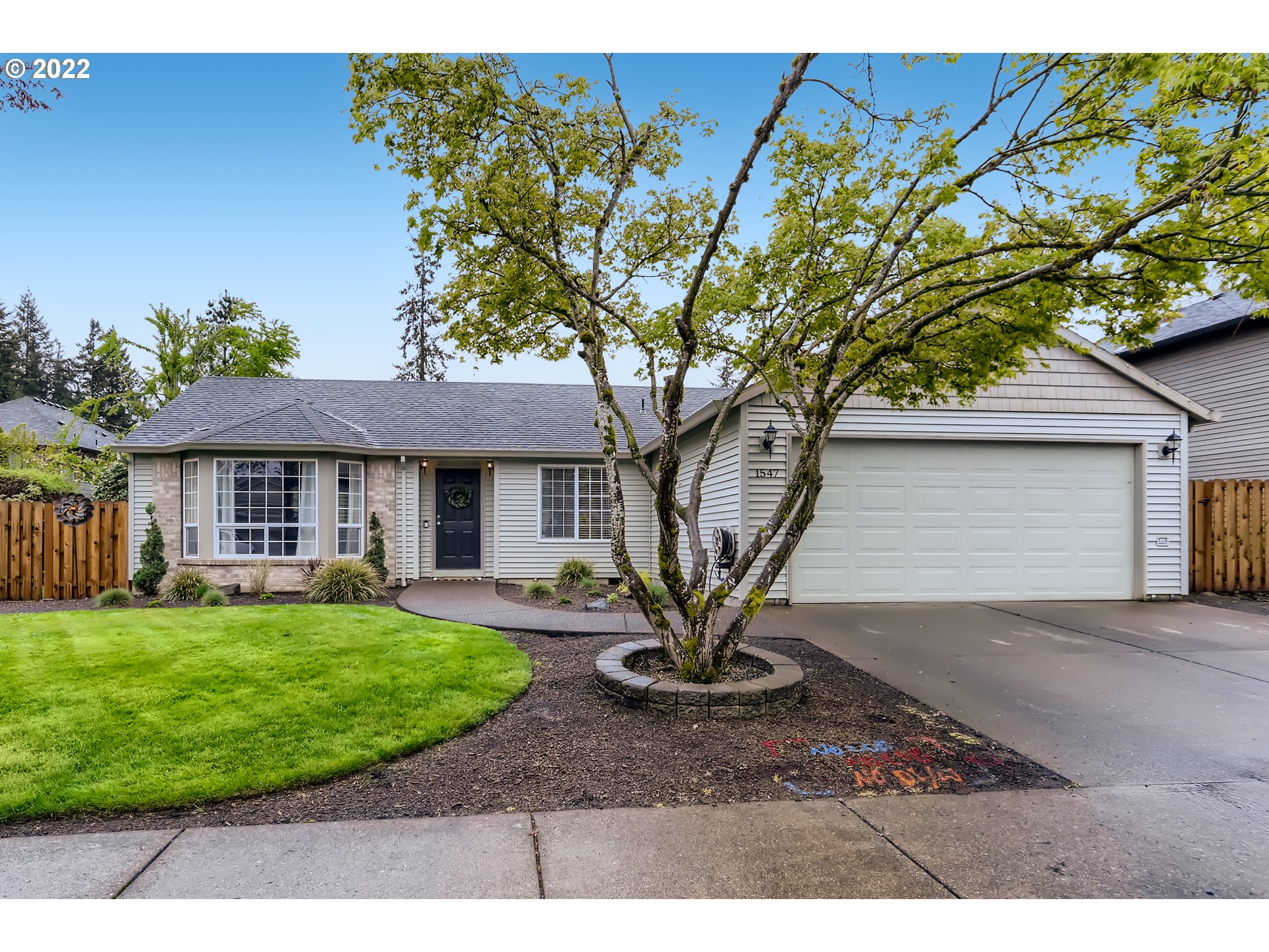 1547 Northeast 19th Loop Canby, OR 97013 - Photo 1 of 28 a front view of a house with a garden and yard