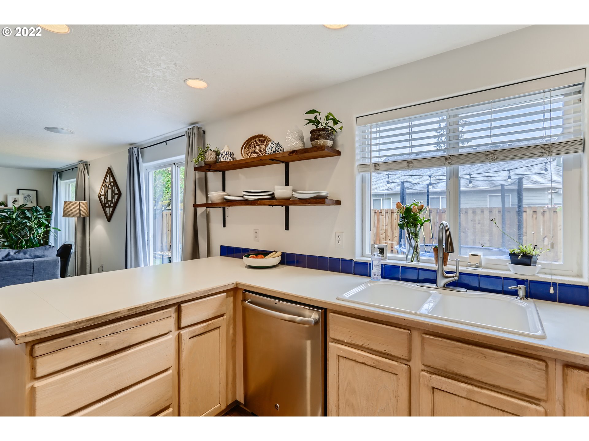 1547 Northeast 19th Loop Canby, OR 97013 - Photo 13 of 28 a kitchen with a sink and a refrigerator