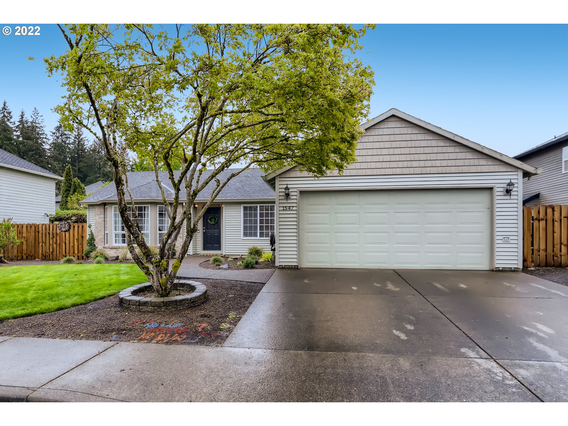 1547 Northeast 19th Loop Canby, OR 97013 - Photo 2 of 28 a front view of a house with a yard and garage