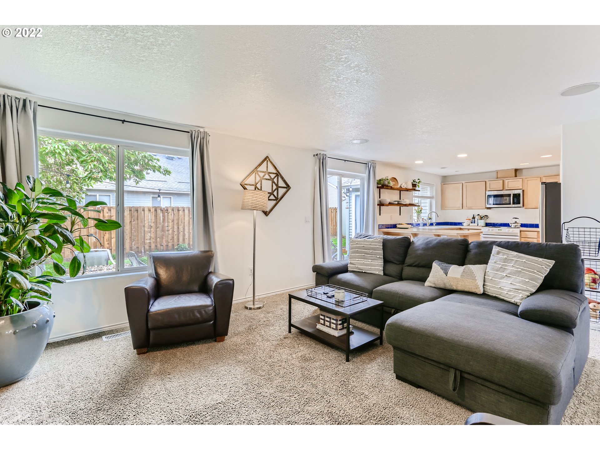 1547 Northeast 19th Loop Canby, OR 97013 - Photo 9 of 28 a living room with furniture and a large window