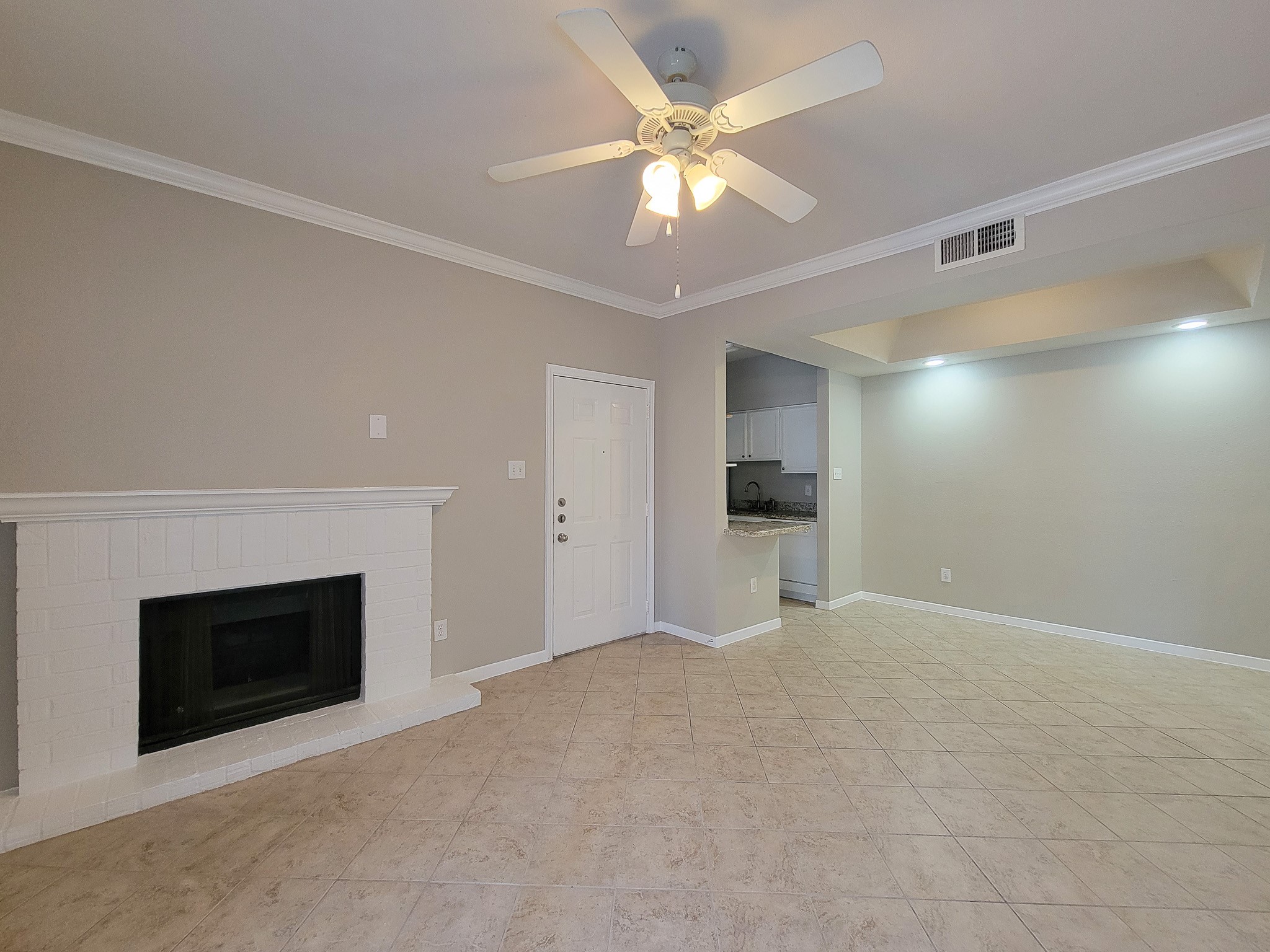 4041 Drake Street, Unit 116 Houston, TX 77005 - Photo 7 of 27 a view of an empty room with a fireplace