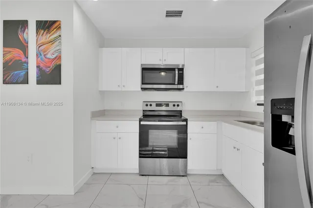 a kitchen with a stove and a microwave