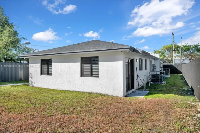 a view of backyard with a garden and deck