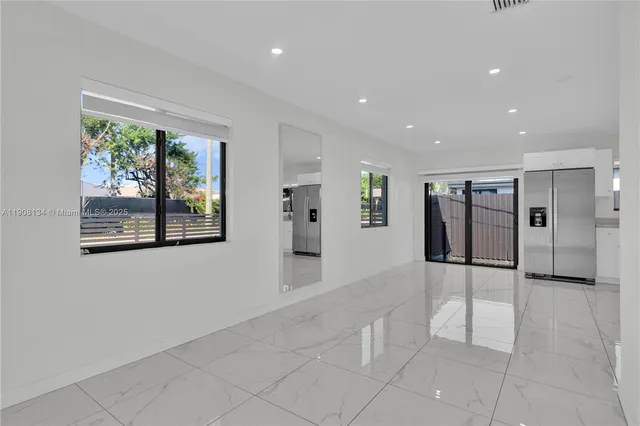a view of a big room with windows and chandelier