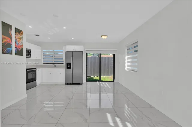 a view of an empty room with glass door