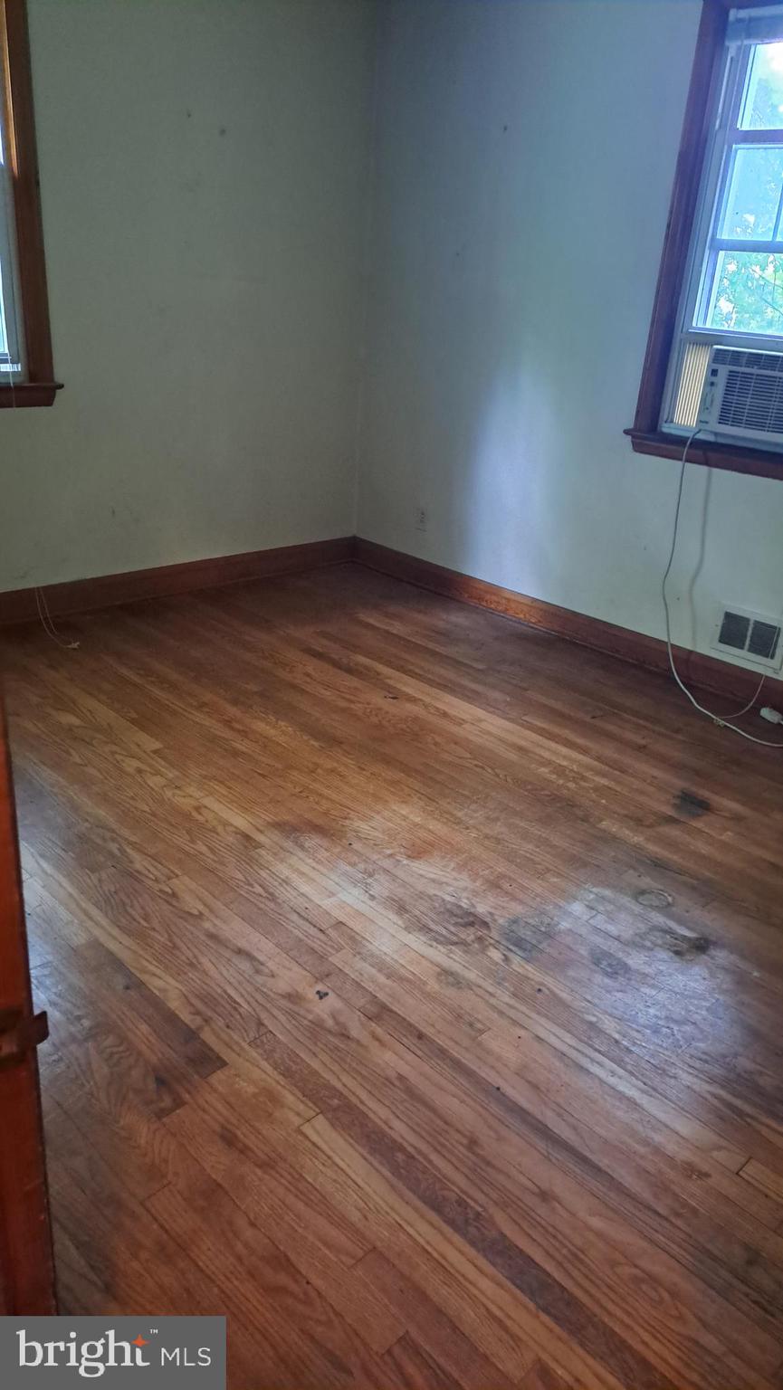 4401 East Joppa Road Perry Hall, MD 21236 - Photo 8 of 32 a view of an empty room with wooden floor and a window