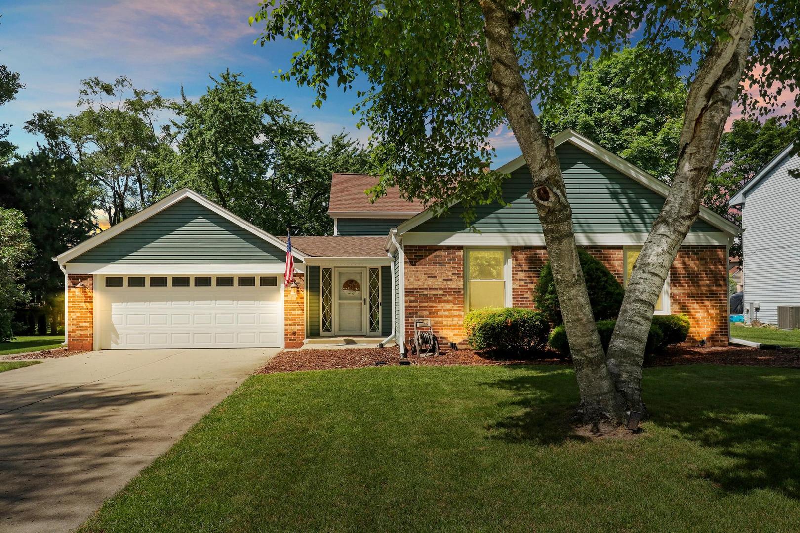 1016 Butler Drive Crystal Lake, IL 60014 - Photo 1 of 20 a front view of house with yard and green space