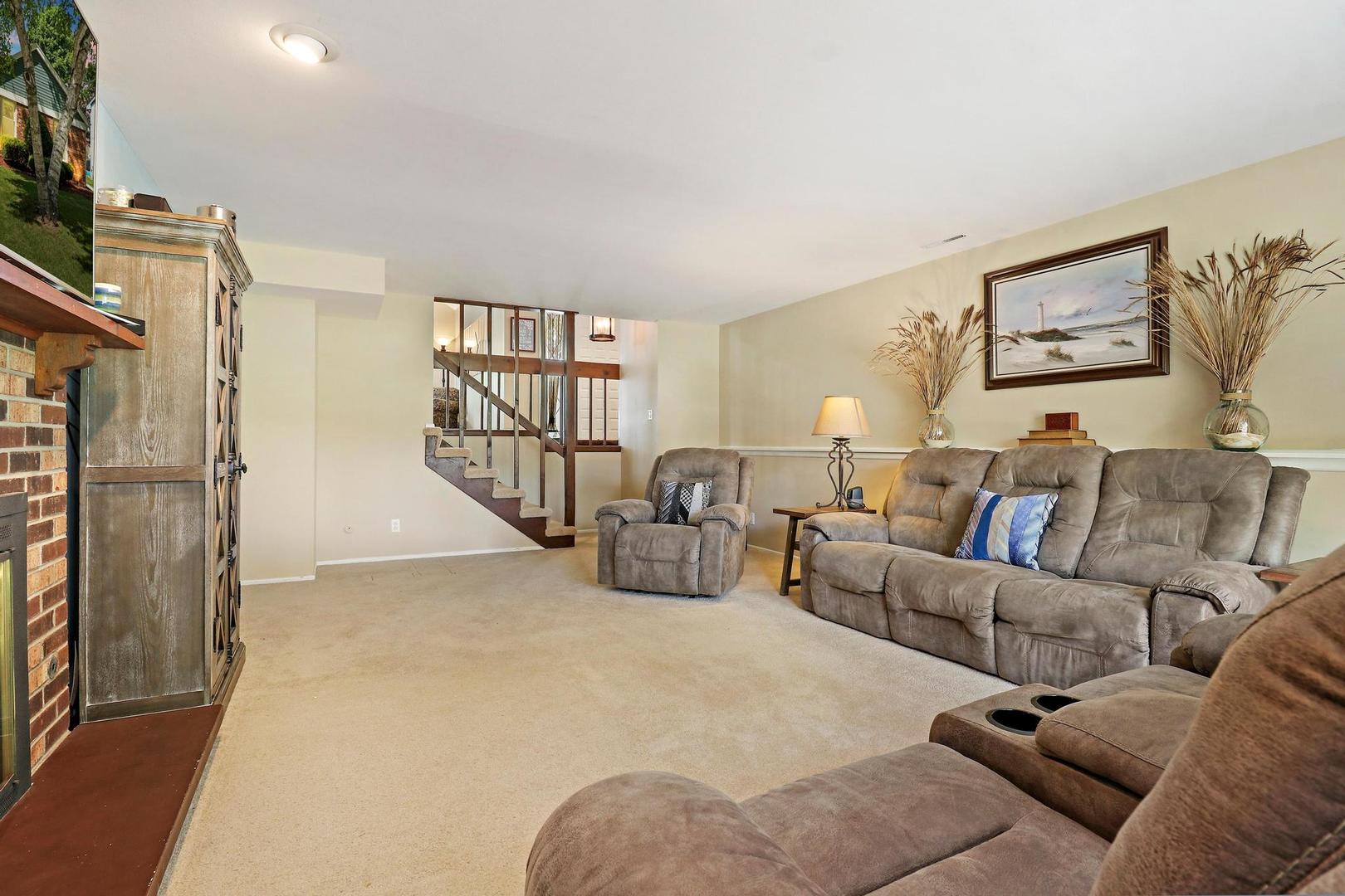 1016 Butler Drive Crystal Lake, IL 60014 - Photo 14 of 20 a living room with furniture a refrigerator and a couch