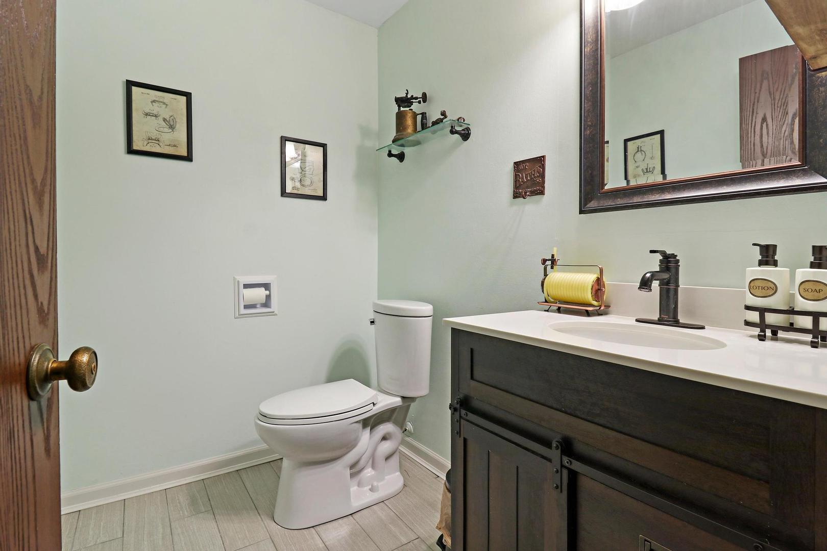 1016 Butler Drive Crystal Lake, IL 60014 - Photo 15 of 20 a bathroom with a sink a toilet and a mirror