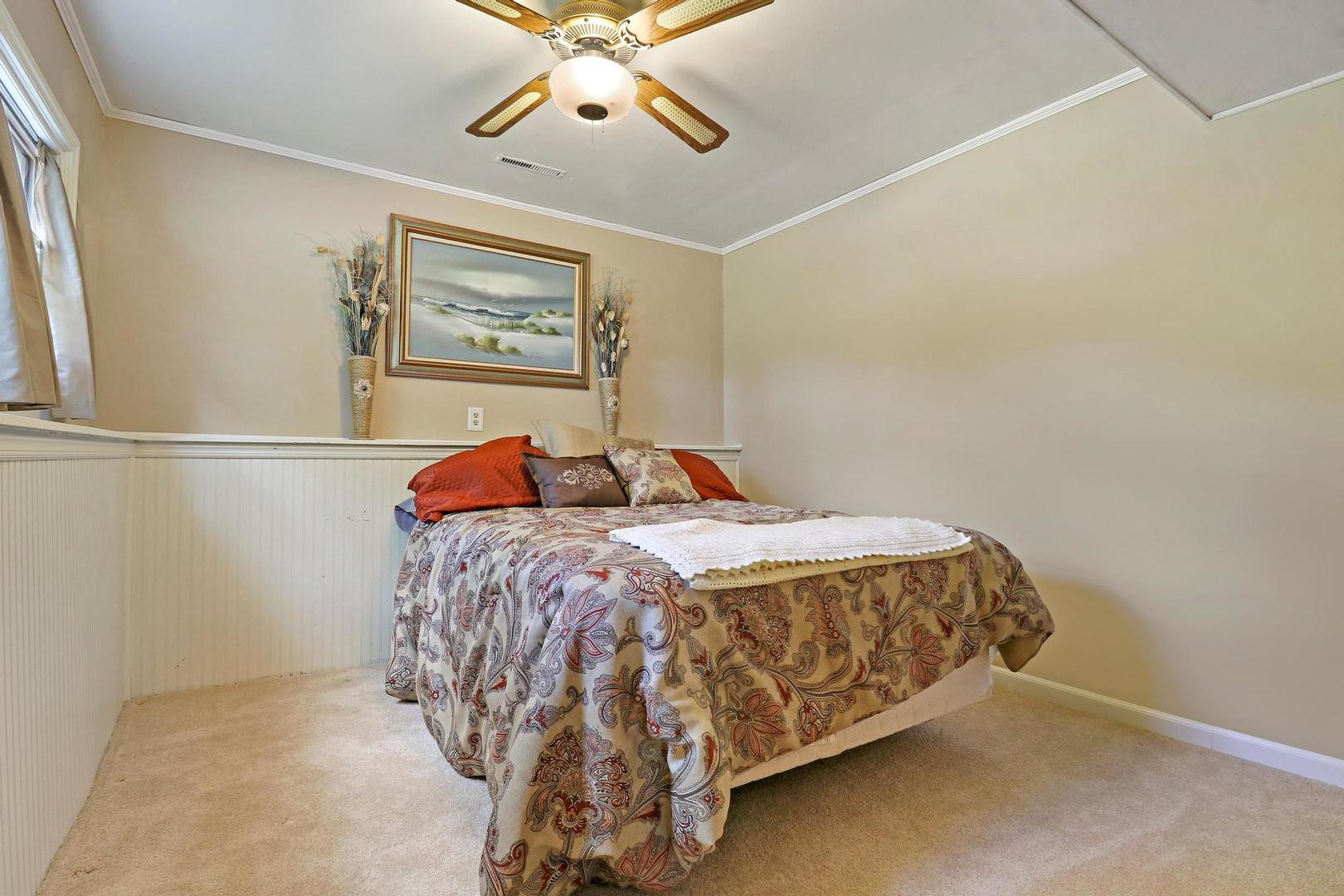 1016 Butler Drive Crystal Lake, IL 60014 - Photo 17 of 20 a bedroom with a bed and a chandelier