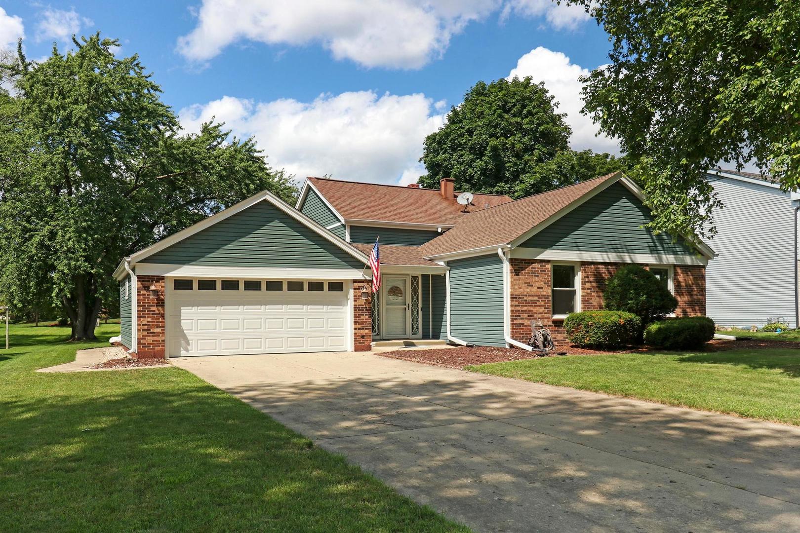 1016 Butler Drive Crystal Lake, IL 60014 - Photo 2 of 20 a front view of a house with a yard and garage