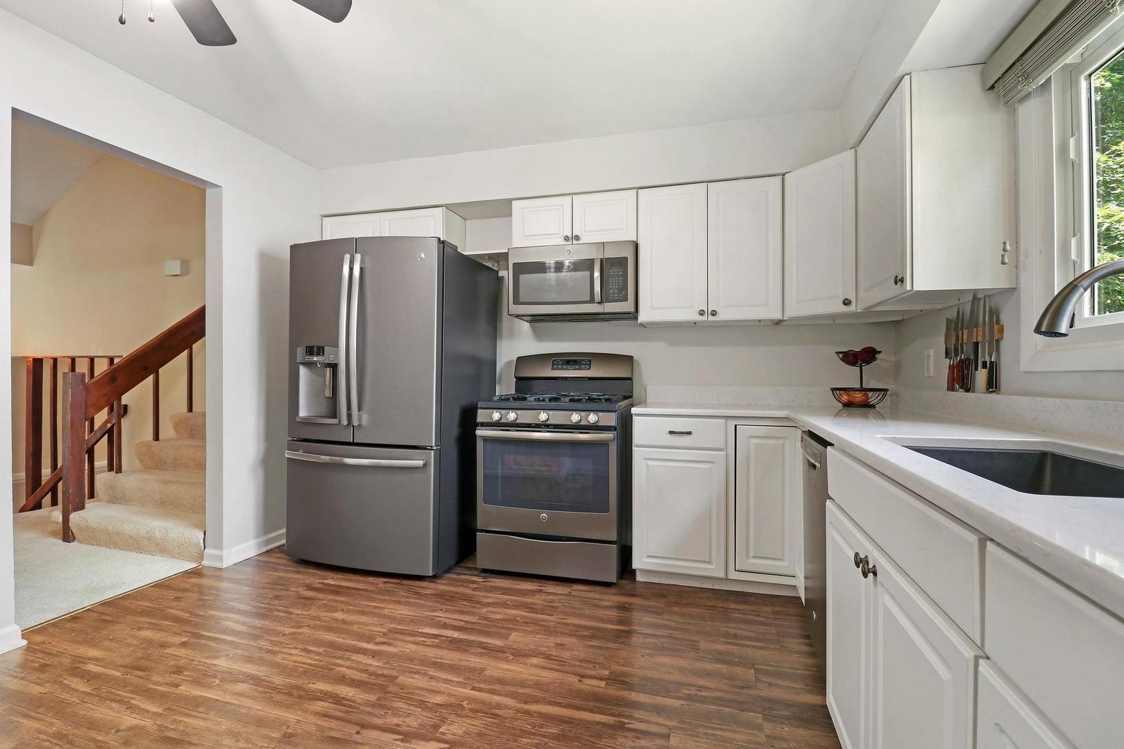 1016 Butler Drive Crystal Lake, IL 60014 - Photo 7 of 20 a kitchen with granite countertop a refrigerator stove and sink