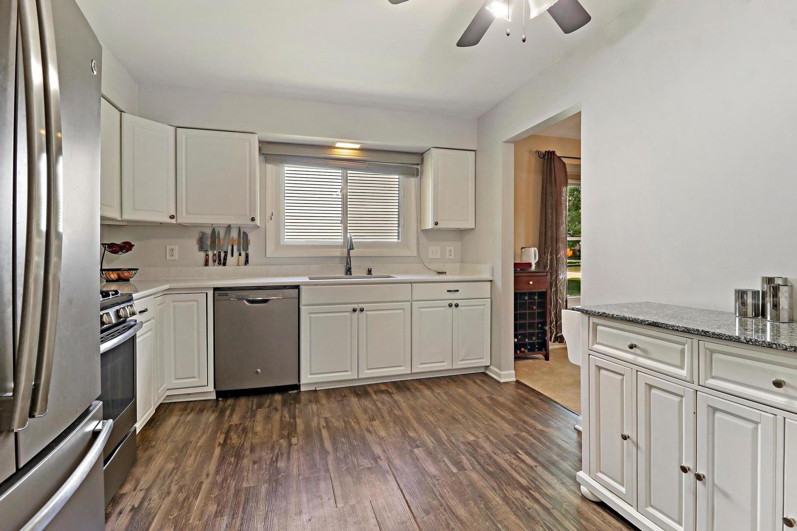 1016 Butler Drive Crystal Lake, IL 60014 - Photo 8 of 20 a kitchen with a sink wooden floor and cabinets