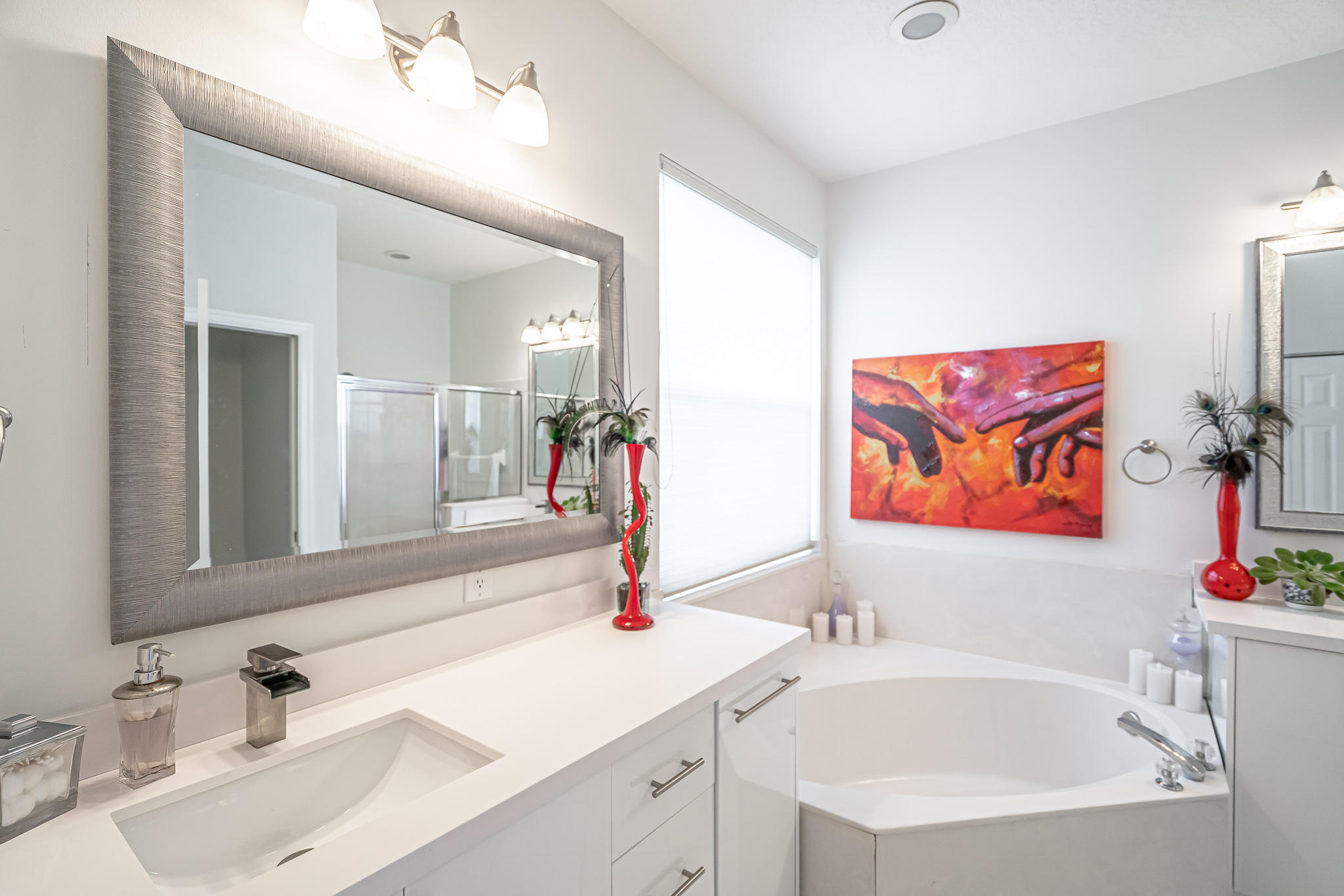 22821 Chelsea Wood Court Boca Raton, FL 33433 - Photo 13 of 43 a bathroom with a tub sink and mirror
