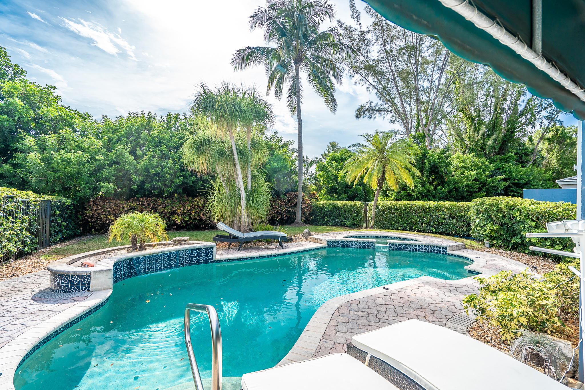 22821 Chelsea Wood Court Boca Raton, FL 33433 - Photo 20 of 43 a view of a swimming pool with a garden and plants