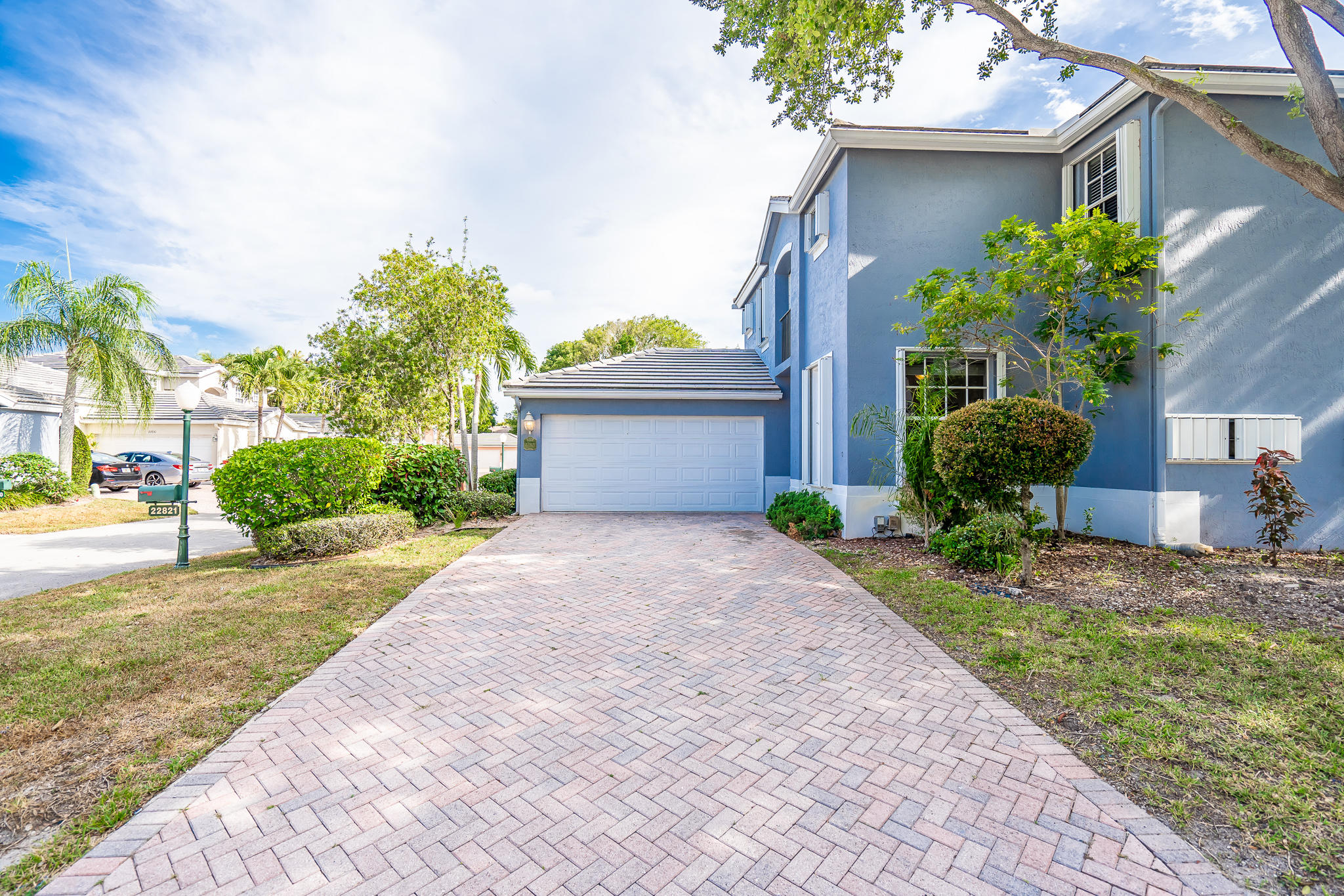 22821 Chelsea Wood Court Boca Raton, FL 33433 - Photo 2 of 43 a front view of a house with garden