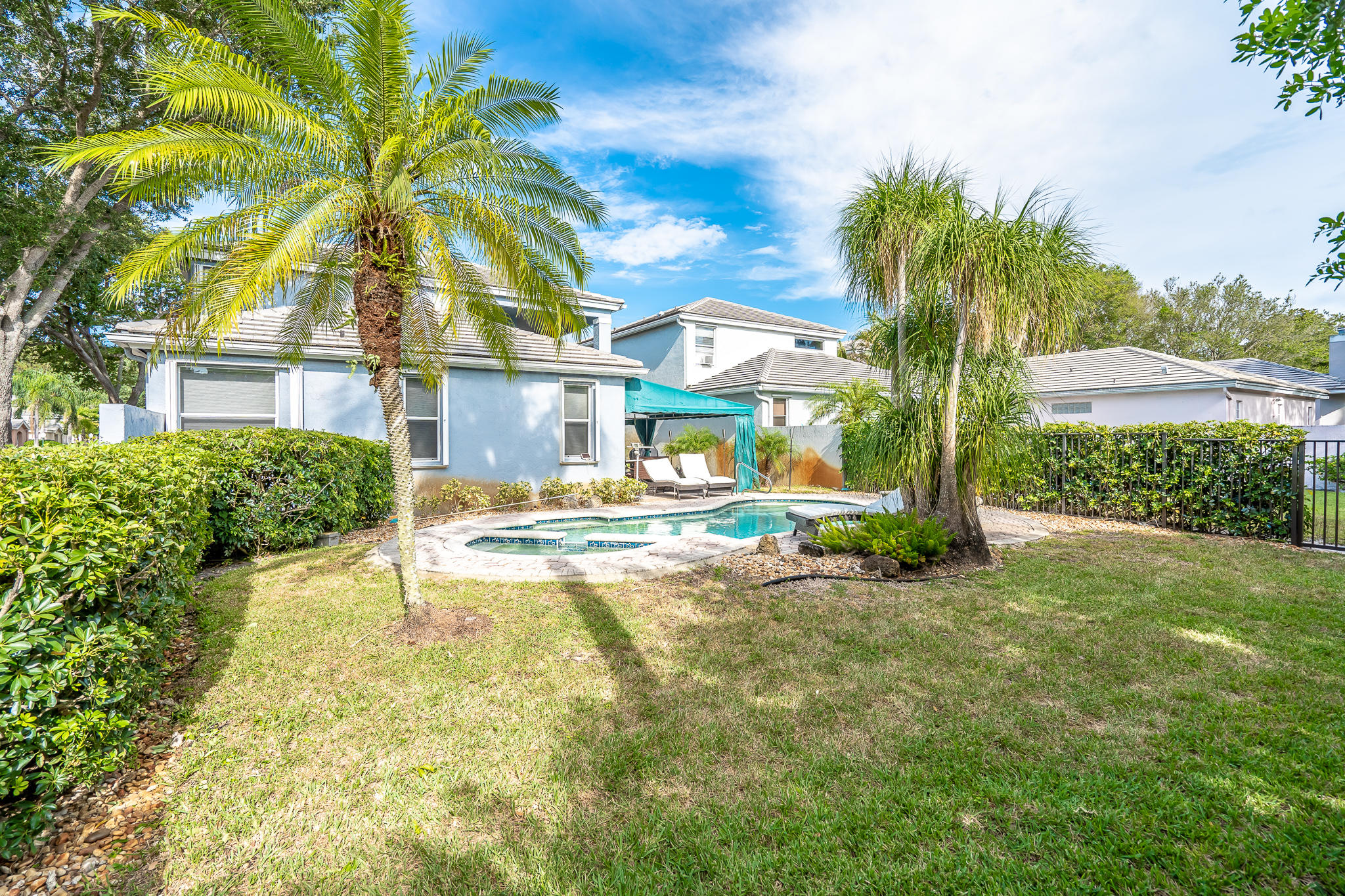 22821 Chelsea Wood Court Boca Raton, FL 33433 - Photo 23 of 43 a view of a house with a yard and palm trees
