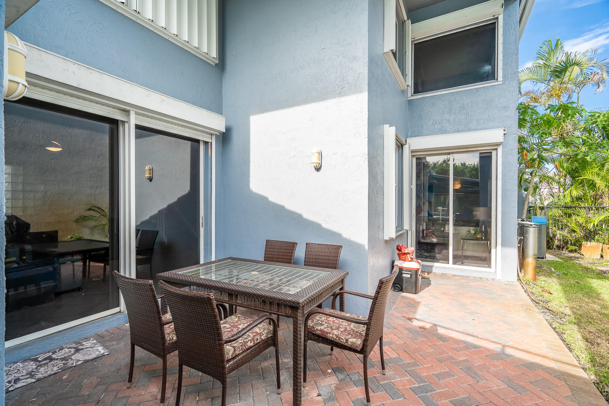 22821 Chelsea Wood Court Boca Raton, FL 33433 - Photo 27 of 43 a patio with a table and chairs and potted plants