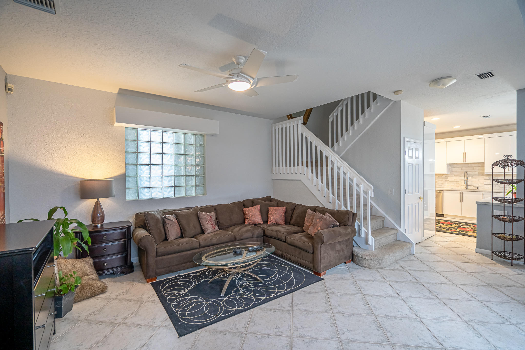 22821 Chelsea Wood Court Boca Raton, FL 33433 - Photo 3 of 43 a living room with furniture ceiling fan and a rug
