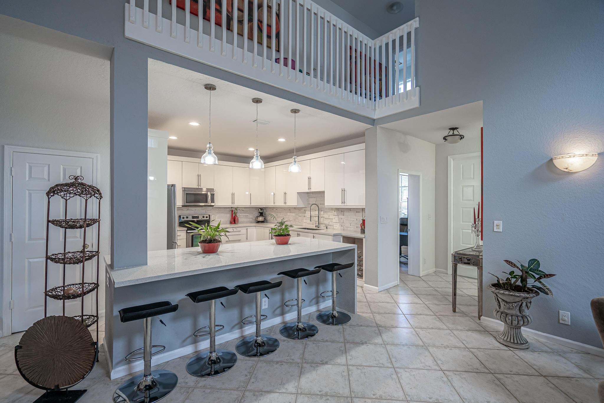 22821 Chelsea Wood Court Boca Raton, FL 33433 - Photo 8 of 43 a kitchen with stainless steel appliances kitchen island granite countertop a sink and cabinets