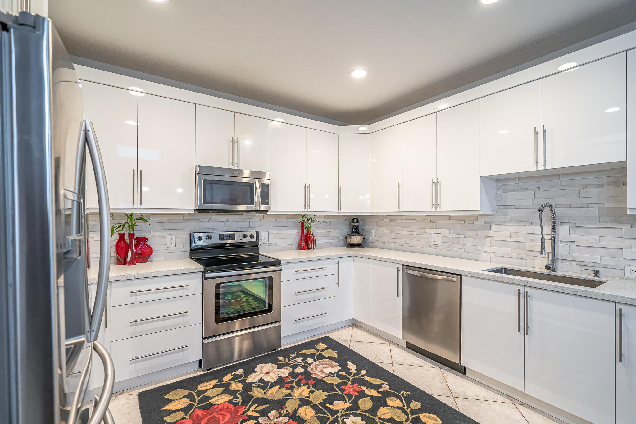22821 Chelsea Wood Court Boca Raton, FL 33433 - Photo 9 of 43 a kitchen with a sink stove and microwave