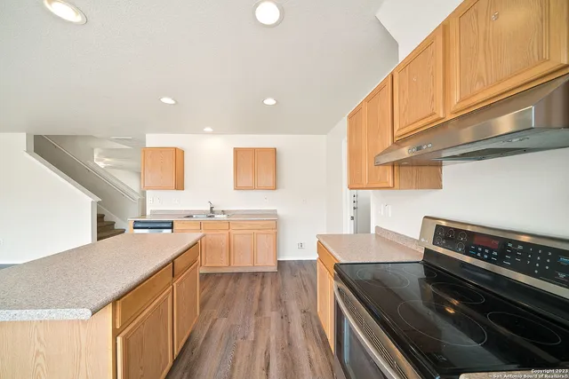 a kitchen with a stove a sink and a refrigerator