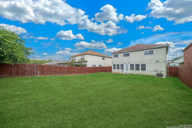 a view of a house with a backyard