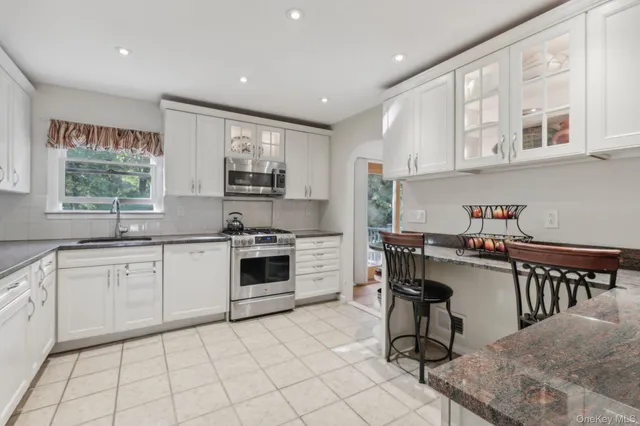 a kitchen with a stove a sink and a microwave