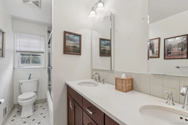 a bathroom with a toilet a sink and mirror