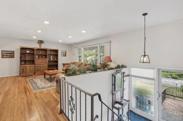 a living room with furniture a fireplace and a floor to ceiling window
