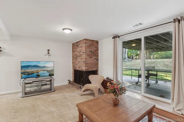 a living room with furniture and a floor to ceiling window