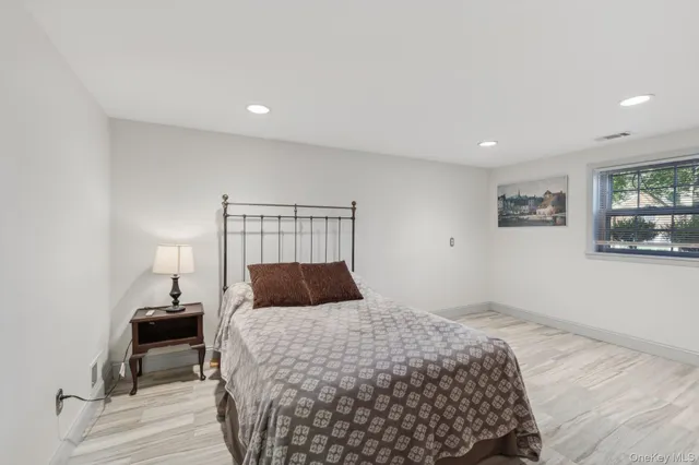 a bedroom with a bed and painting on the wall