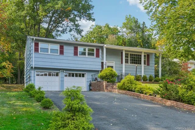 a view of a house with a backyard and a patio