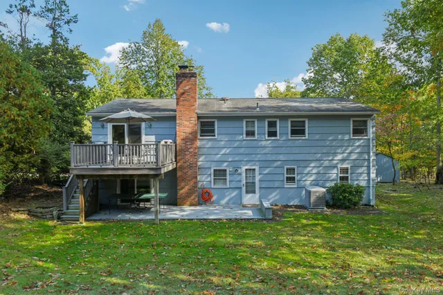 a view of a house with a backyard and a patio