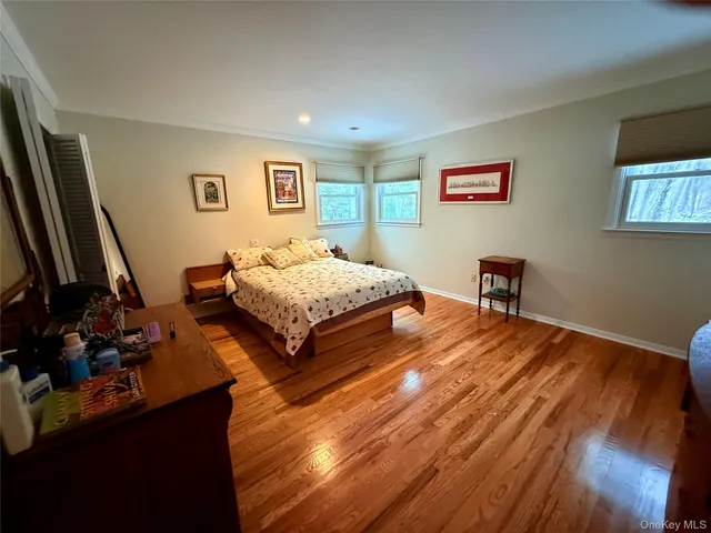 a bedroom with two beds and a desk