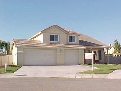 14367 Ponderosa Ranch Road Victorville, CA 92392 - Photo 1 of 1 a front view of a house with a yard and garage