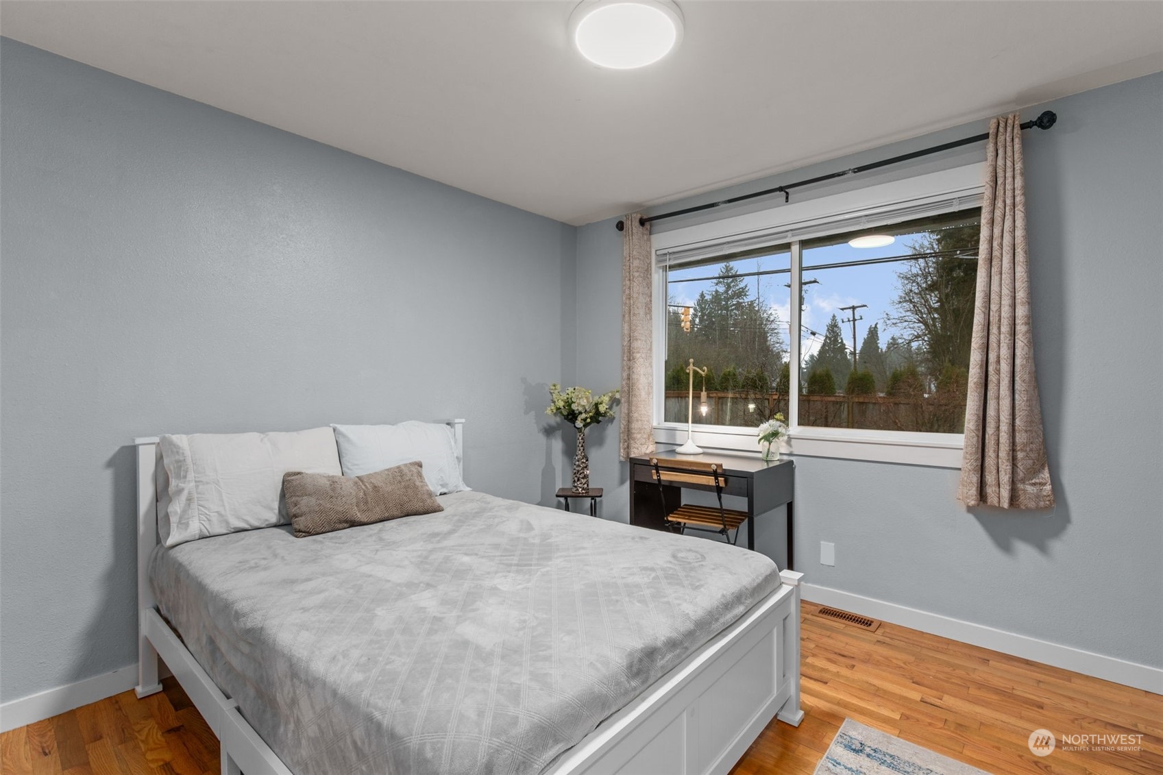 15608 Southeast 128th Street Renton, WA 98059 - Photo 21 of 40 a bedroom with a large bed and a window