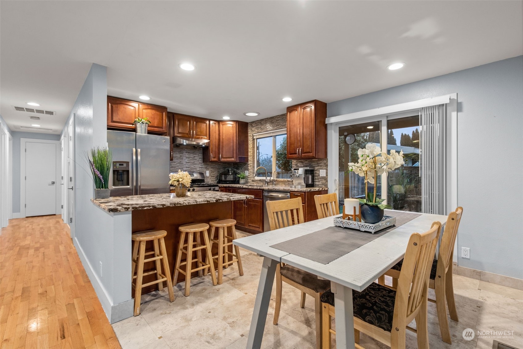 15608 Southeast 128th Street Renton, WA 98059 - Photo 7 of 40 a kitchen with a table and chairs in it