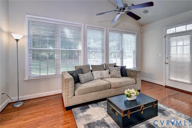 a living room with furniture and wooden floor
