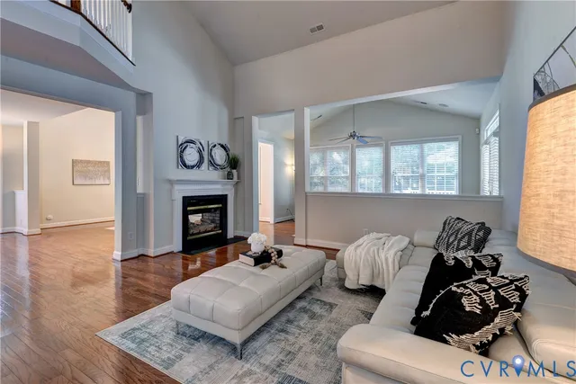 a living room with furniture and wooden floor