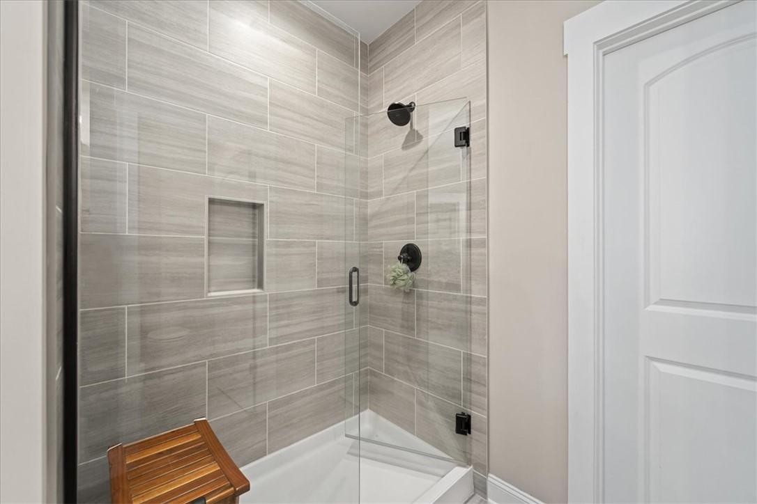6834 Midway Road Pelzer, SC 29669 - Photo 28 of 50 This modern bathroom features a sleek, tiled shower for a refreshing daily routine.