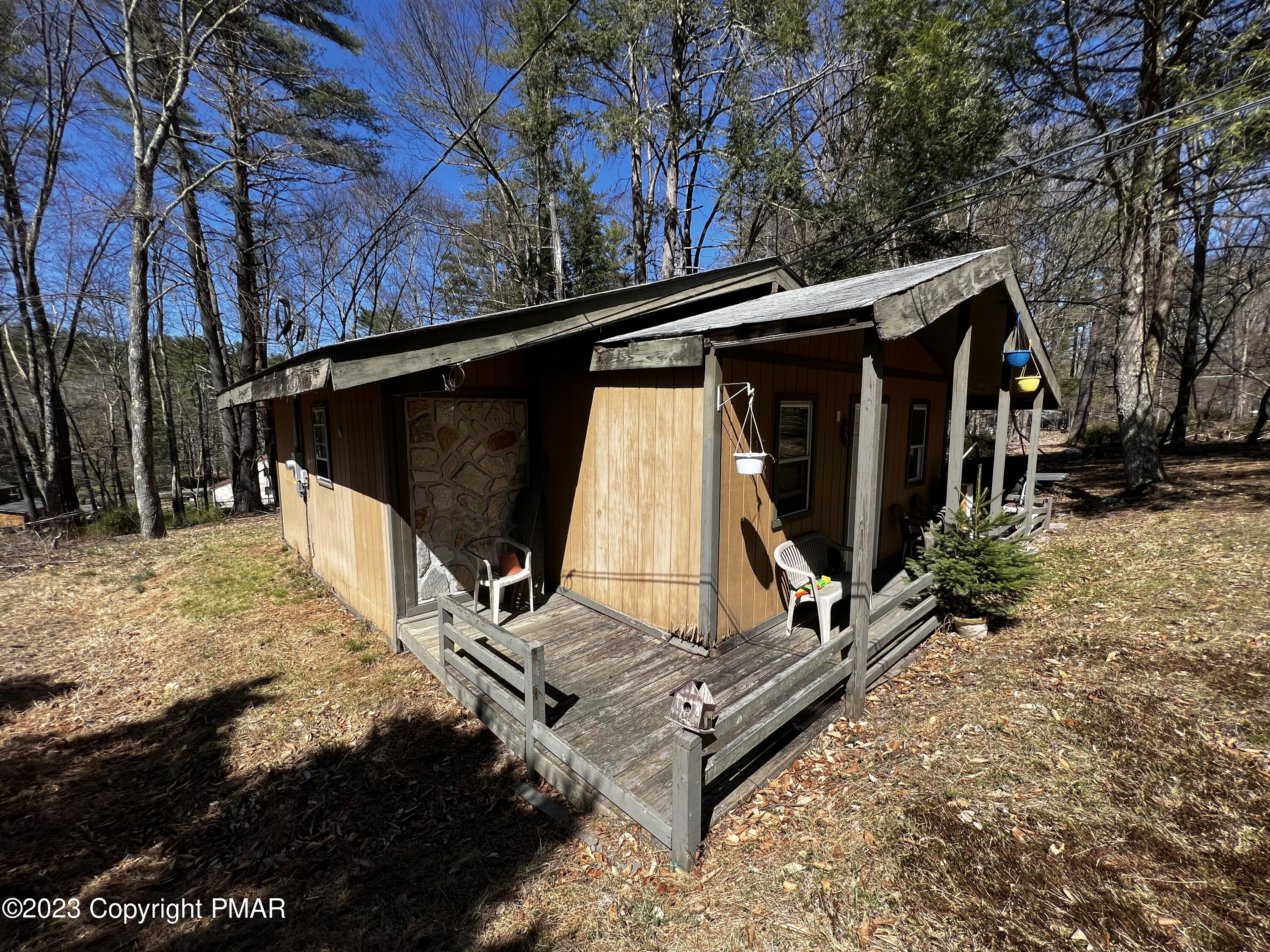 108 Mink Lane Bushkill, PA 18324 - Photo 2 of 15 a view of backyard with wooden fence and a bench