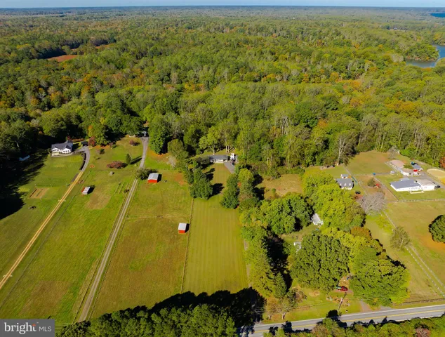 an aerial view of a residential houses with outdoor space
