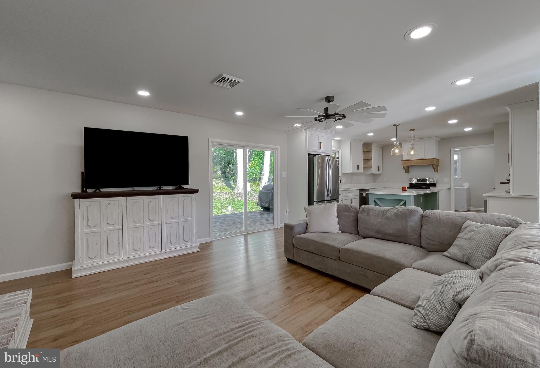 26005 Jones Wharf Road Hollywood, MD 20636 - Photo 12 of 66 a living room with furniture and a flat screen tv