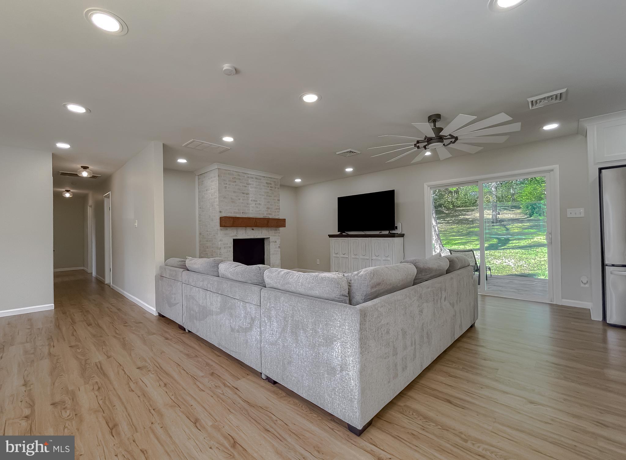 26005 Jones Wharf Road Hollywood, MD 20636 - Photo 14 of 66 a living room with furniture and a flat screen tv